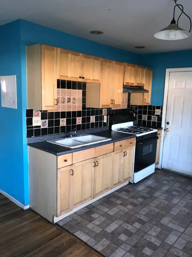 Vacant kitchen with blue walls and light wood cabinets, Brentwood, NY